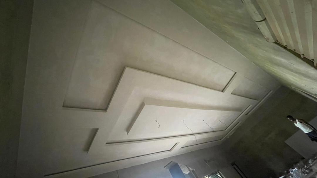 Finishing crew reviewing millwork templates inside a residence